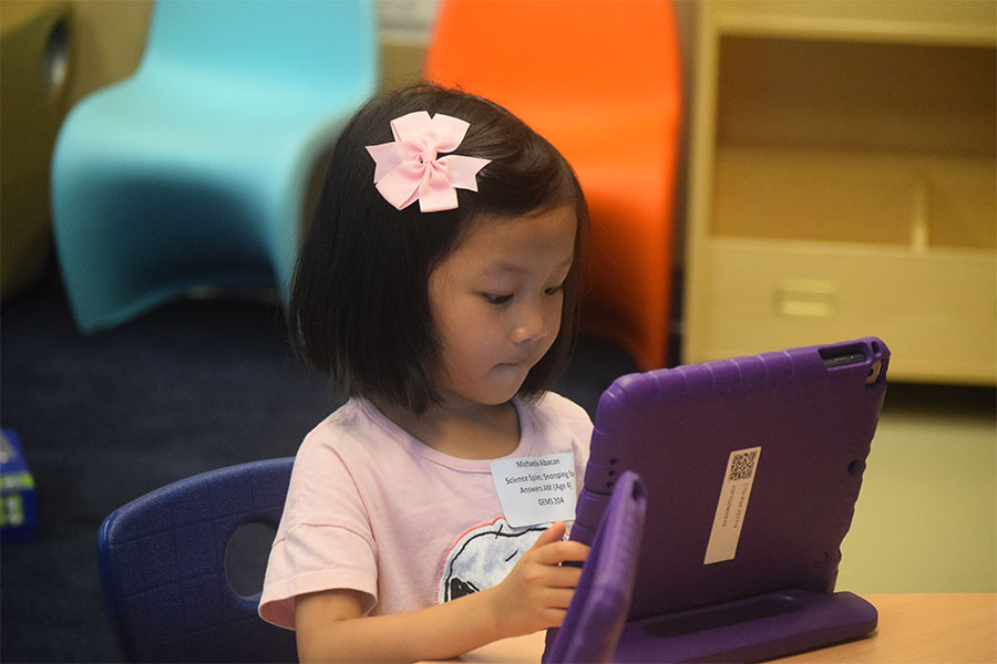 kindergarten girl using iPad in class
