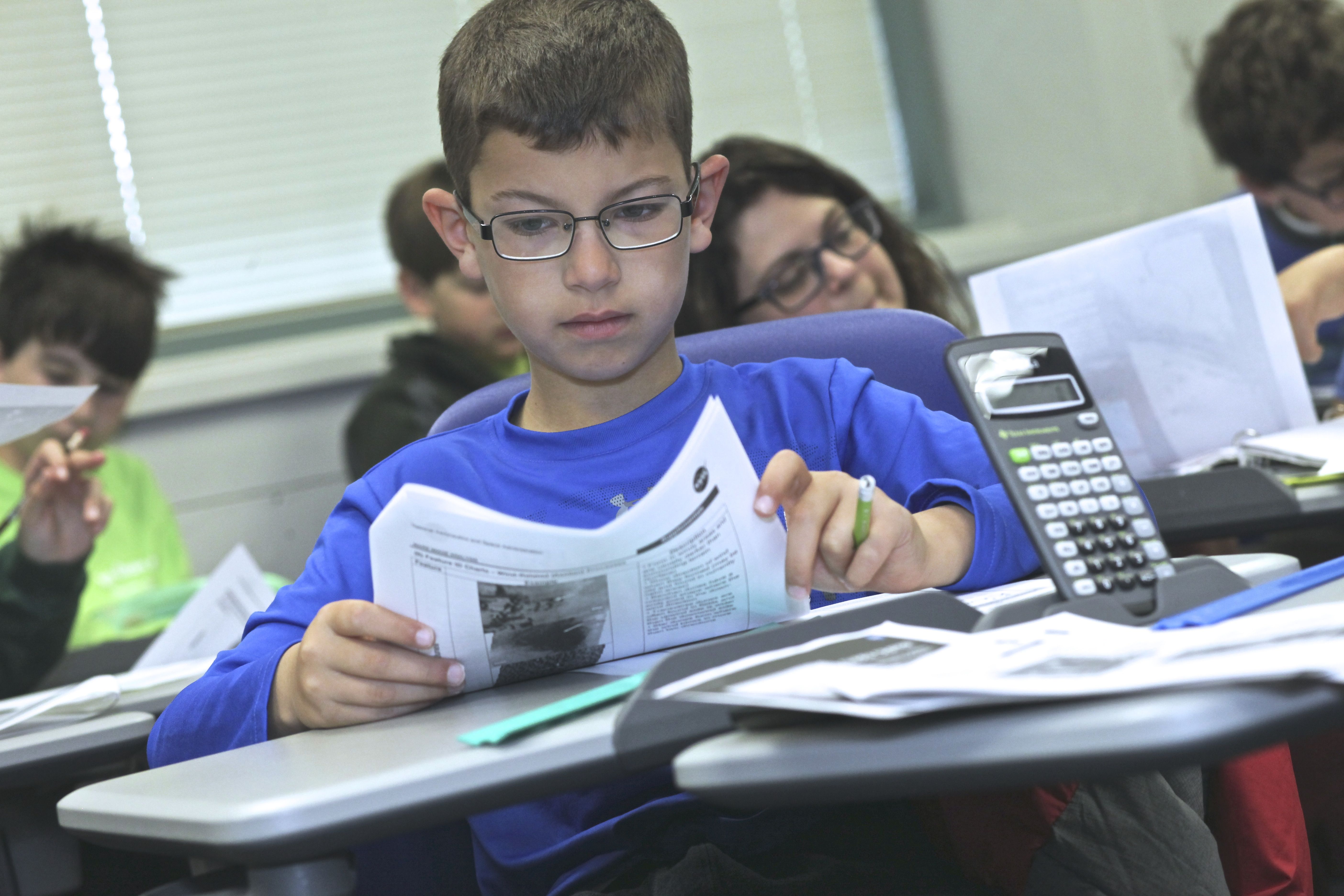 Middle school student with papers