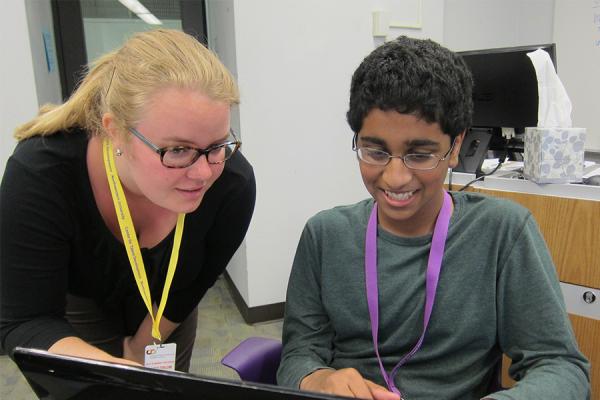 teacher working with middle school student